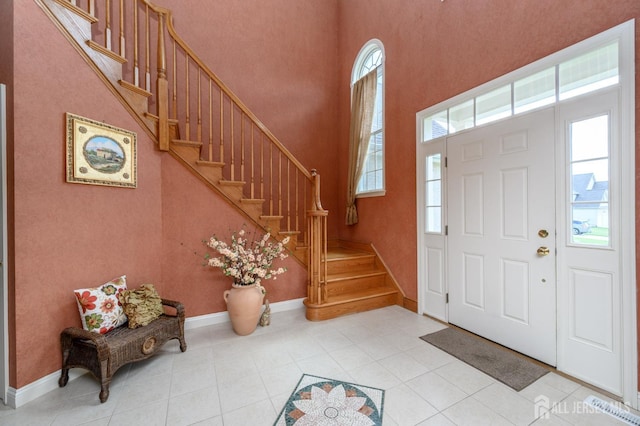 15 Heather Ct, Mansfield, NJ 08022 - foyer entrance featuring light tile patterned floors, a towering ceiling, stairs, and baseboards