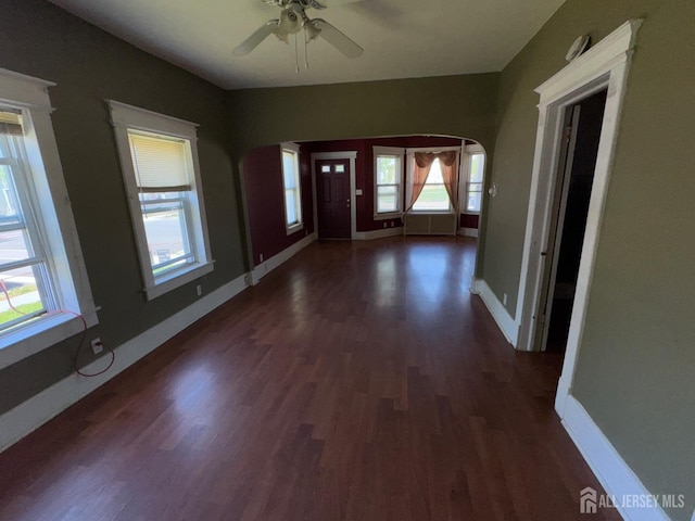 134 S Stevens Ave S, South Amboy, NJ 08879 - foyer with arched walkways, dark wood-type flooring, a ceiling fan, and baseboards