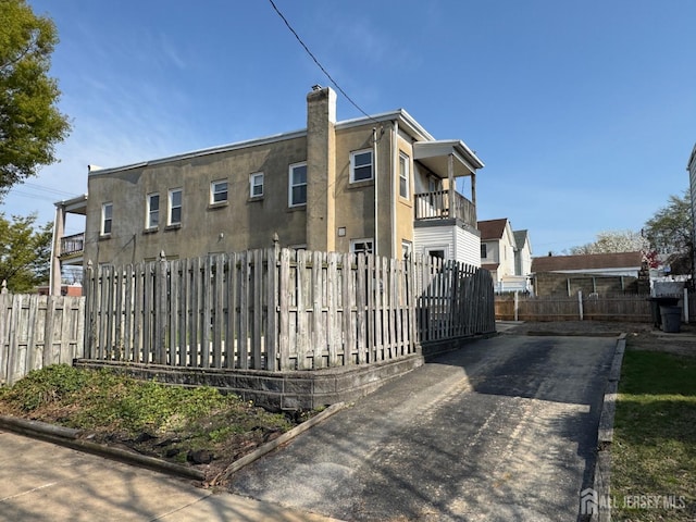 134 S Stevens Ave S, South Amboy, NJ 08879 - view of front facade with a balcony, a fenced front yard, and a chimney