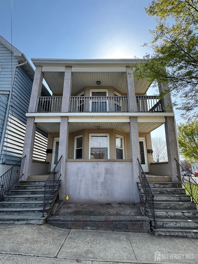 134 S Stevens Ave S, South Amboy, NJ 08879 - townhome / multi-family property with a balcony, stucco siding, and stairway