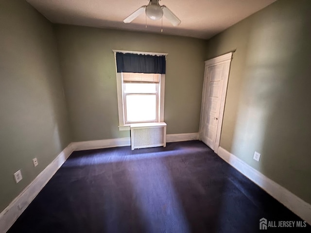 134 S Stevens Ave S, South Amboy, NJ 08879 - unfurnished bedroom with baseboards, dark carpet, and ceiling fan