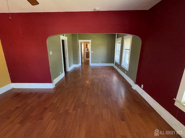 134 S Stevens Ave S, South Amboy, NJ 08879 - empty room featuring arched walkways, wood finished floors, baseboards, and ceiling fan