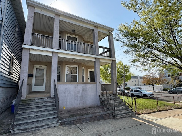 134 S Stevens Ave S, South Amboy, NJ 08879 - multi unit property featuring a balcony, fence, stucco siding, and a porch