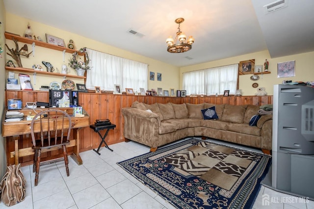 living room with a chandelier and light tile patterned flooring