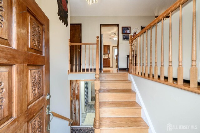 staircase with ceiling fan