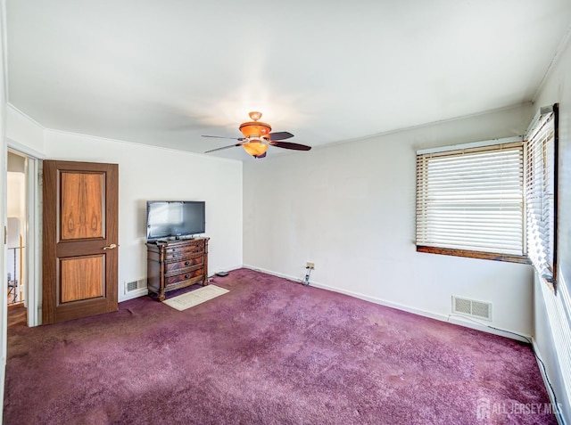 unfurnished living room with ceiling fan and dark carpet