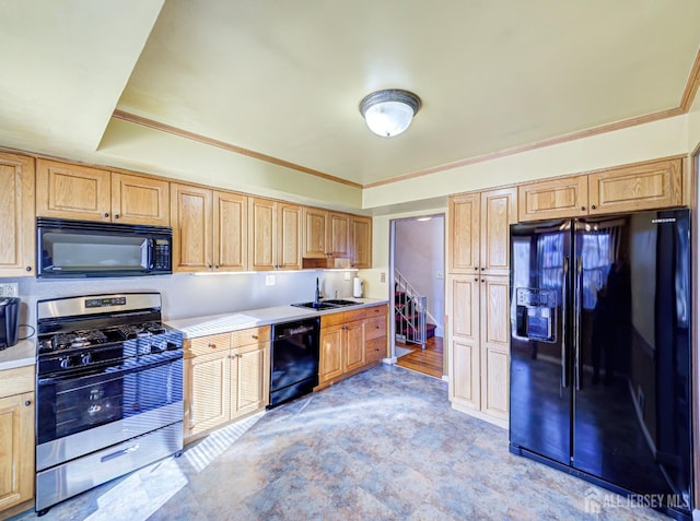 kitchen with black appliances, crown molding, and sink