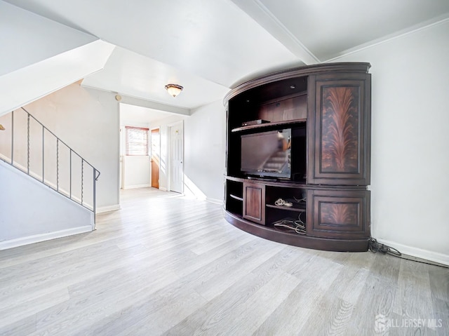 unfurnished living room with light hardwood / wood-style flooring and crown molding