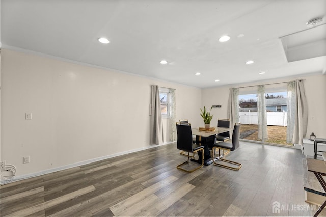 dining space with recessed lighting, a healthy amount of sunlight, wood finished floors, and crown molding