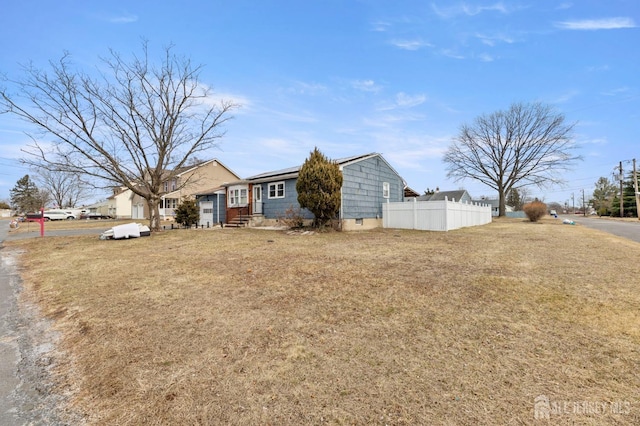 single story home featuring crawl space, solar panels, a front yard, and fence