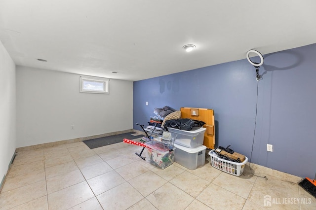 below grade area featuring tile patterned floors and baseboards