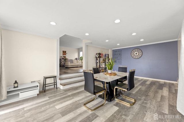 dining area featuring recessed lighting, wood finished floors, and ornamental molding