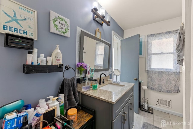 bathroom featuring visible vents, baseboards, vanity, and tile patterned flooring