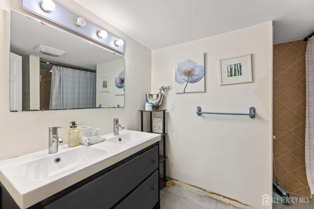 bathroom featuring a sink, a shower with shower curtain, double vanity, and tile patterned floors