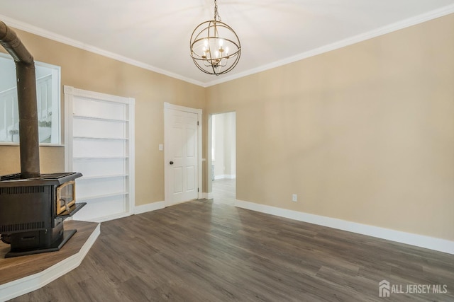 interior space with a wood stove, built in shelves, dark wood-type flooring, a chandelier, and ornamental molding