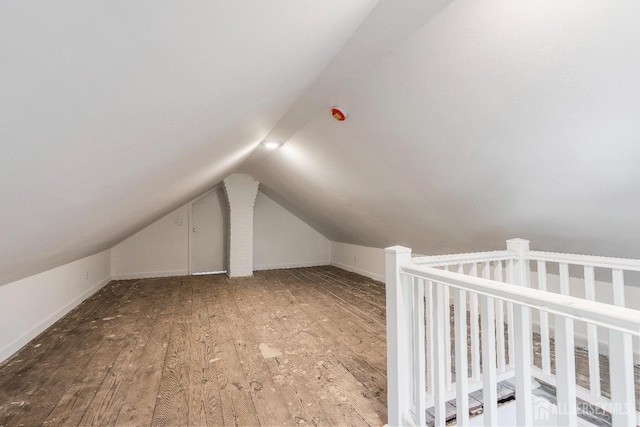 additional living space featuring hardwood / wood-style flooring and lofted ceiling