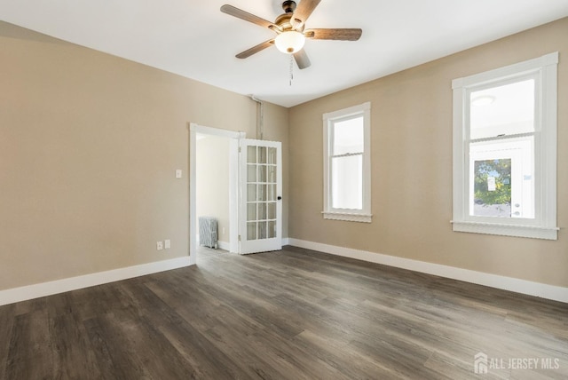 spare room featuring dark hardwood / wood-style flooring and ceiling fan