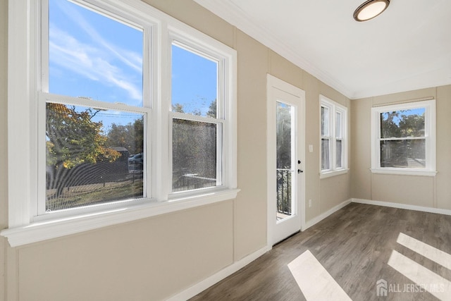 interior space with dark hardwood / wood-style flooring and ornamental molding