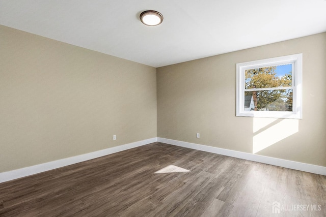 unfurnished room featuring dark hardwood / wood-style floors