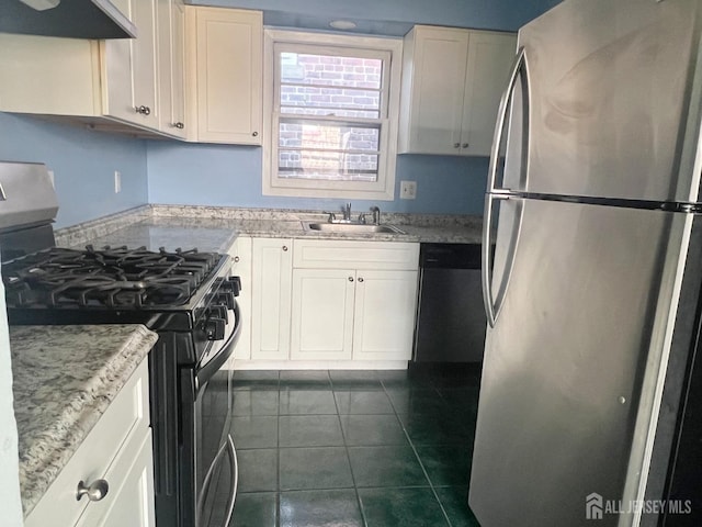 kitchen with appliances with stainless steel finishes, ventilation hood, dark tile patterned floors, sink, and white cabinets