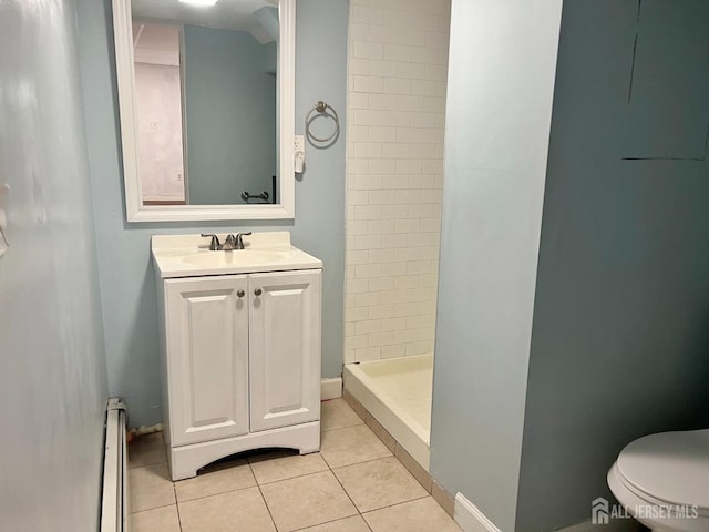 bathroom with vanity, a baseboard heating unit, tile patterned flooring, toilet, and tiled shower