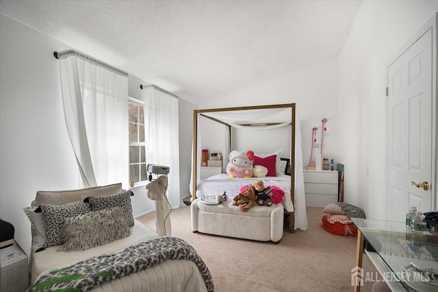 carpeted bedroom featuring vaulted ceiling and a textured ceiling