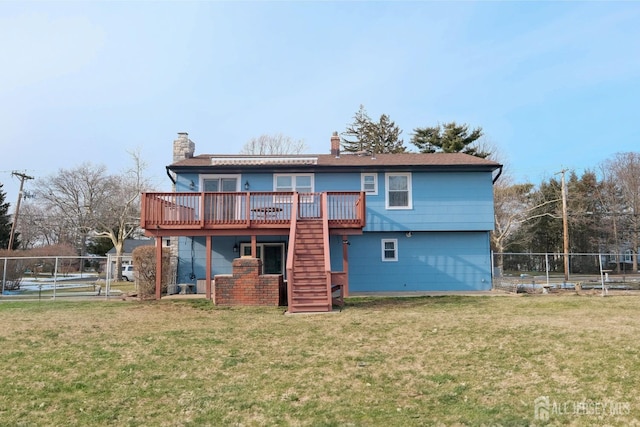 back of house with a chimney, fence, a wooden deck, a lawn, and stairs