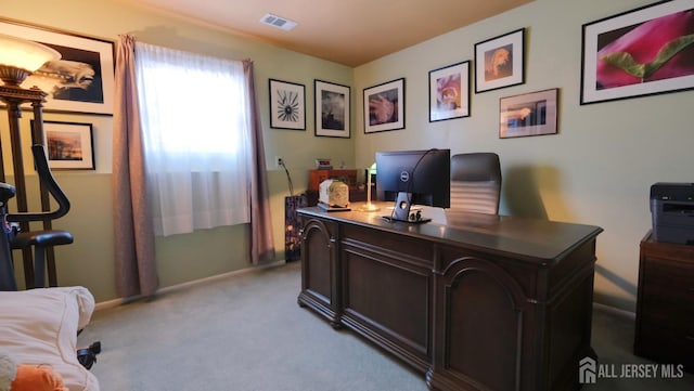 home office featuring visible vents, baseboards, and light carpet