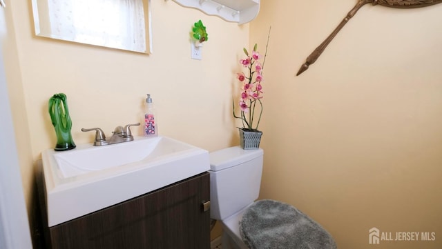 bathroom with vanity and toilet