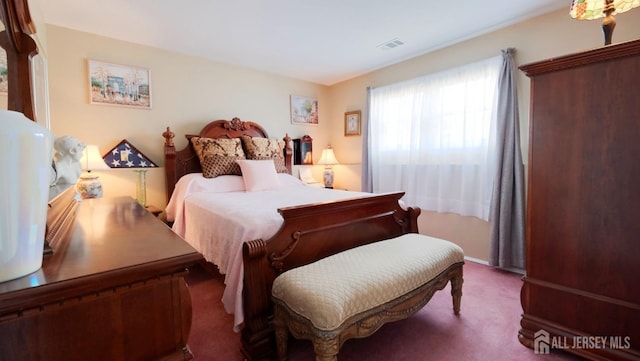 carpeted bedroom with visible vents