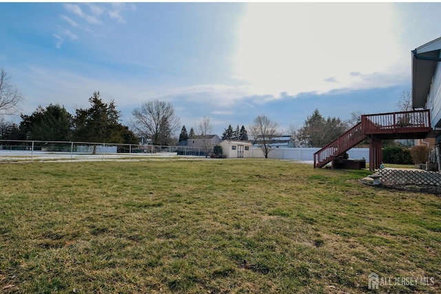 view of yard with stairway, fence, and a deck