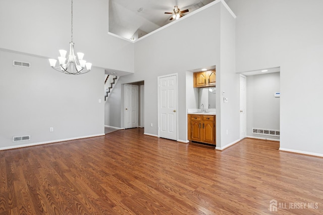 unfurnished living room featuring visible vents and wood finished floors