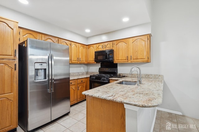 kitchen with light tile patterned floors, a peninsula, light stone countertops, black appliances, and a sink