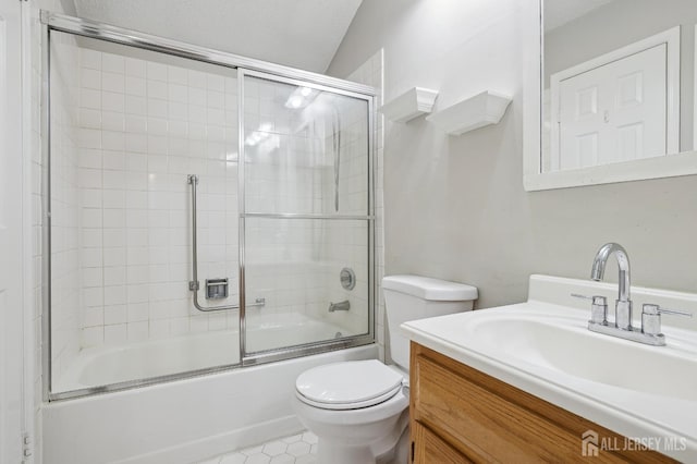 full bath featuring toilet, shower / bath combination with glass door, and vanity