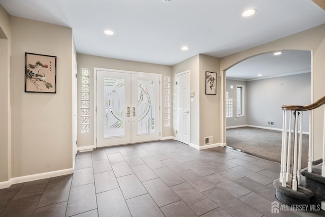 16 Darby Rd, East Brunswick, NJ 08816 - tiled foyer featuring arched walkways, stairs, recessed lighting, baseboards, and french doors
