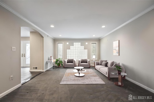 16 Darby Rd, East Brunswick, NJ 08816 - carpeted living room featuring arched walkways, crown molding, baseboards, and recessed lighting