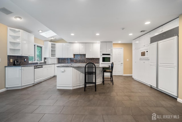 16 Darby Rd, East Brunswick, NJ 08816 - kitchen with open shelves, decorative backsplash, white cabinetry, and recessed lighting