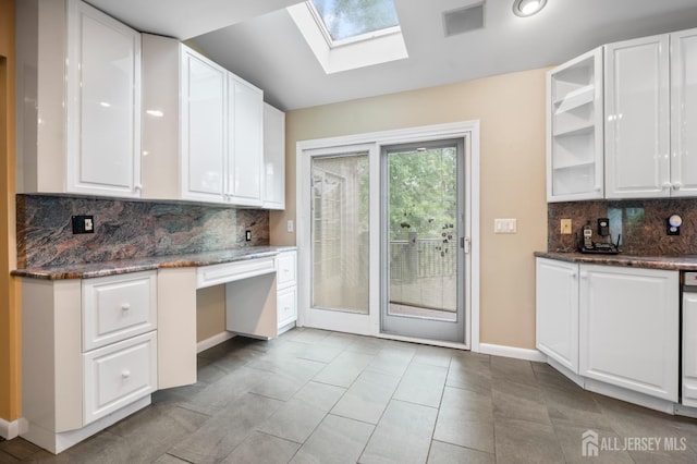 16 Darby Rd, East Brunswick, NJ 08816 - kitchen with a skylight, white cabinetry, tasteful backsplash, baseboards, and dark stone countertops