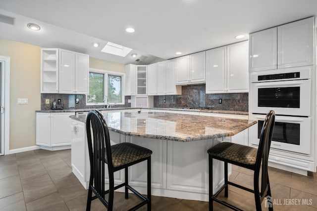 16 Darby Rd, East Brunswick, NJ 08816 - kitchen featuring white double oven, open shelves, white cabinets, a kitchen island, and recessed lighting
