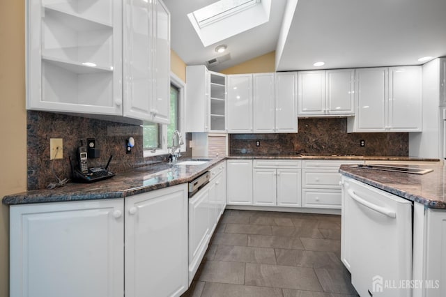 16 Darby Rd, East Brunswick, NJ 08816 - kitchen with white dishwasher, a sink, white cabinetry, a skylight, and dark stone counters