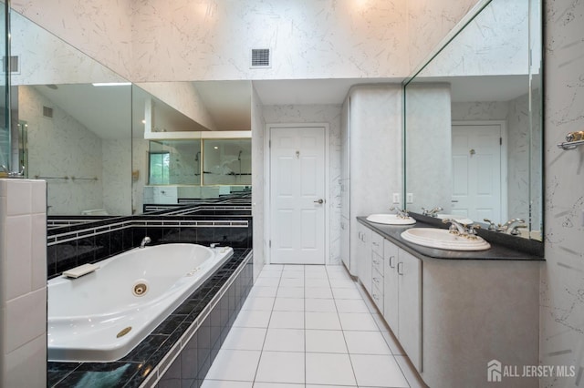 16 Darby Rd, East Brunswick, NJ 08816 - bathroom featuring a tub with jets, double vanity, and tile patterned flooring