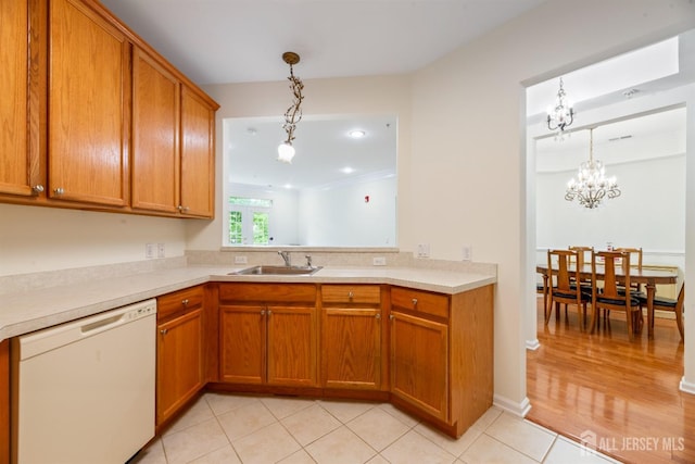 2206 Cedar Village Blvd, East Brunswick, NJ 08816 - kitchen with dishwasher, brown cabinets, pendant lighting, and light countertops