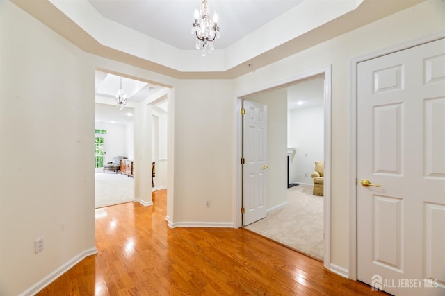 2206 Cedar Village Blvd, East Brunswick, NJ 08816 - corridor with a chandelier and light wood-type flooring