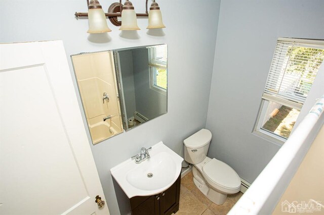 full bathroom with toilet, a baseboard heating unit, tile patterned floors, tub / shower combination, and vanity