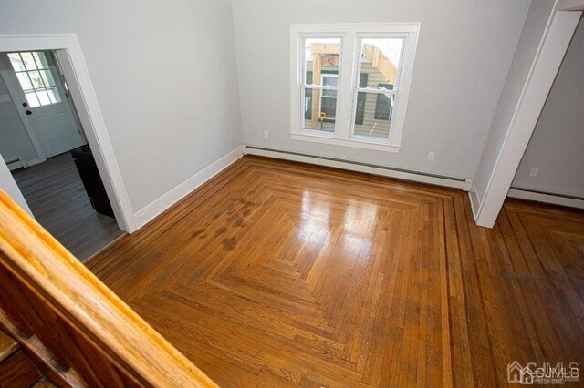 interior space with plenty of natural light and a baseboard radiator