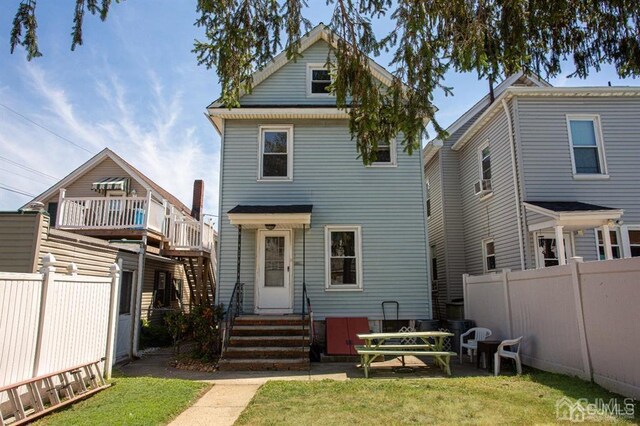 rear view of property featuring a yard