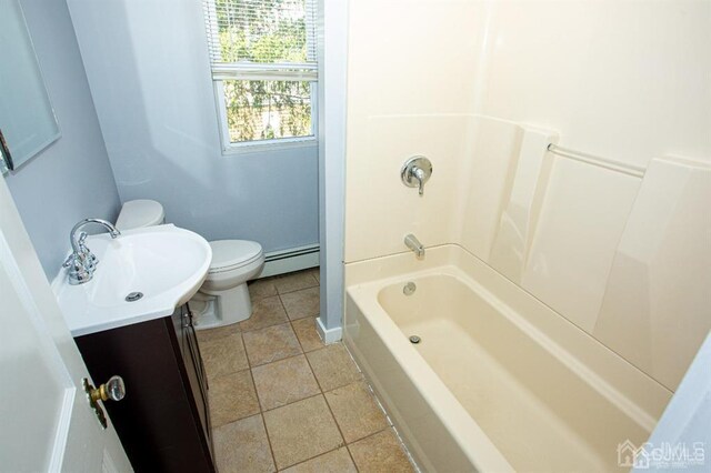 bathroom with toilet, vanity, tile patterned floors, and a baseboard radiator