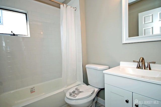 full bathroom with vanity, shower / bath combination with curtain, and toilet