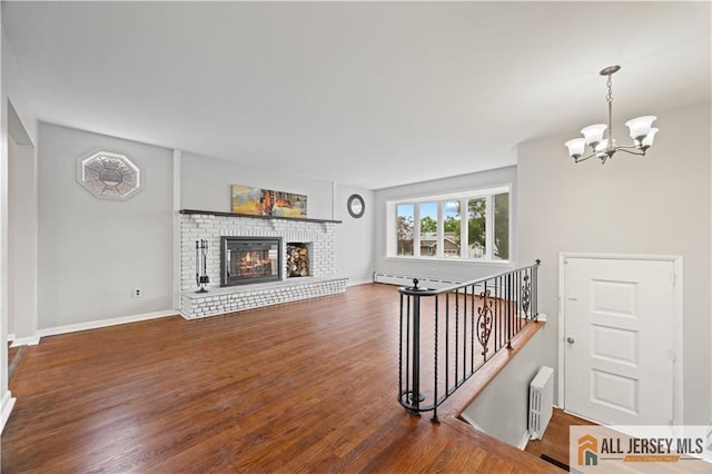 11 Amendola Dr, Netcong, NJ 07857 - living room featuring baseboard heating, radiator heating unit, a chandelier, wood finished floors, and a fireplace