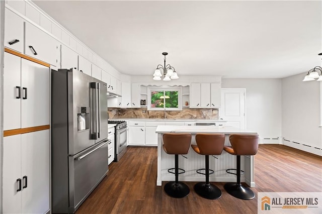 11 Amendola Dr, Netcong, NJ 07857 - kitchen with stainless steel appliances, a chandelier, decorative backsplash, white cabinets, and dark wood-type flooring